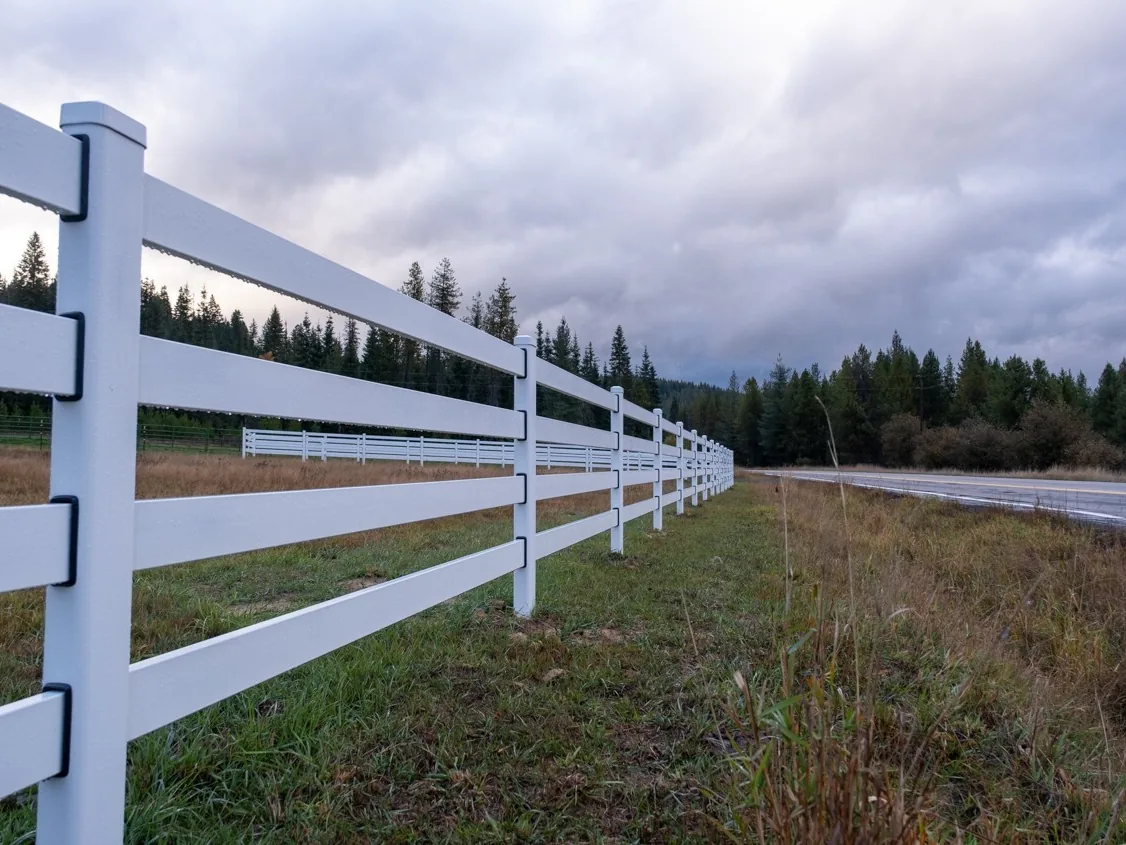 Closer overcast view along white Buckley Steel Board fencing at the Clarkia horse property