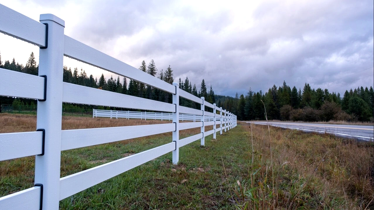 White Buckley Steel Board fence running along the roadside at the Clarkia, Idaho horse property