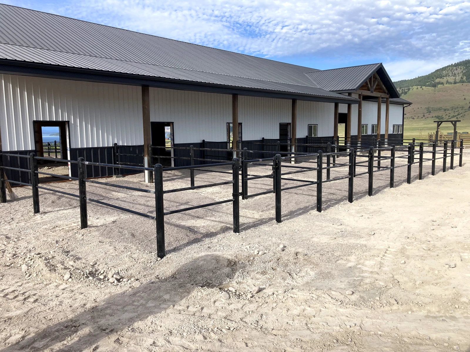Black Priefert Estate Fence running along the side of the Montana paddocks