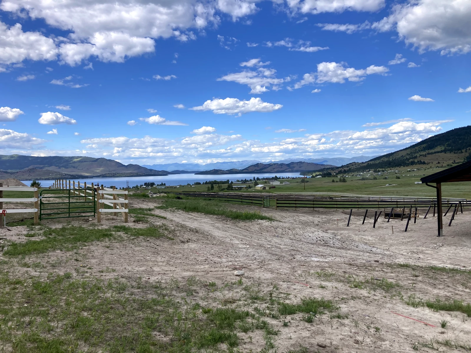 White board fence and gate overlooking the Montana valley near the paddock project