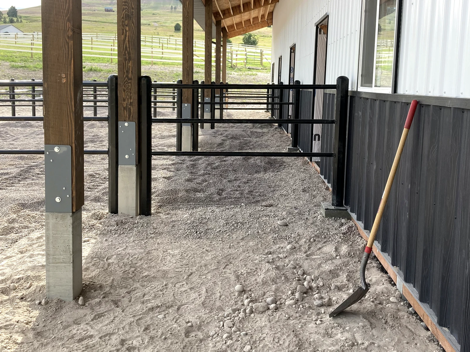 Black Priefert Estate Fence beneath the covered barn run in Montana