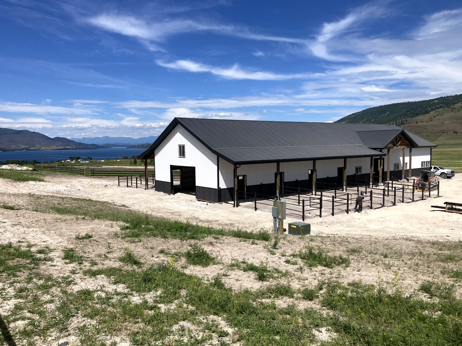 Black Priefert Estate Fence turning around the barn corner in Big Arm, Montana