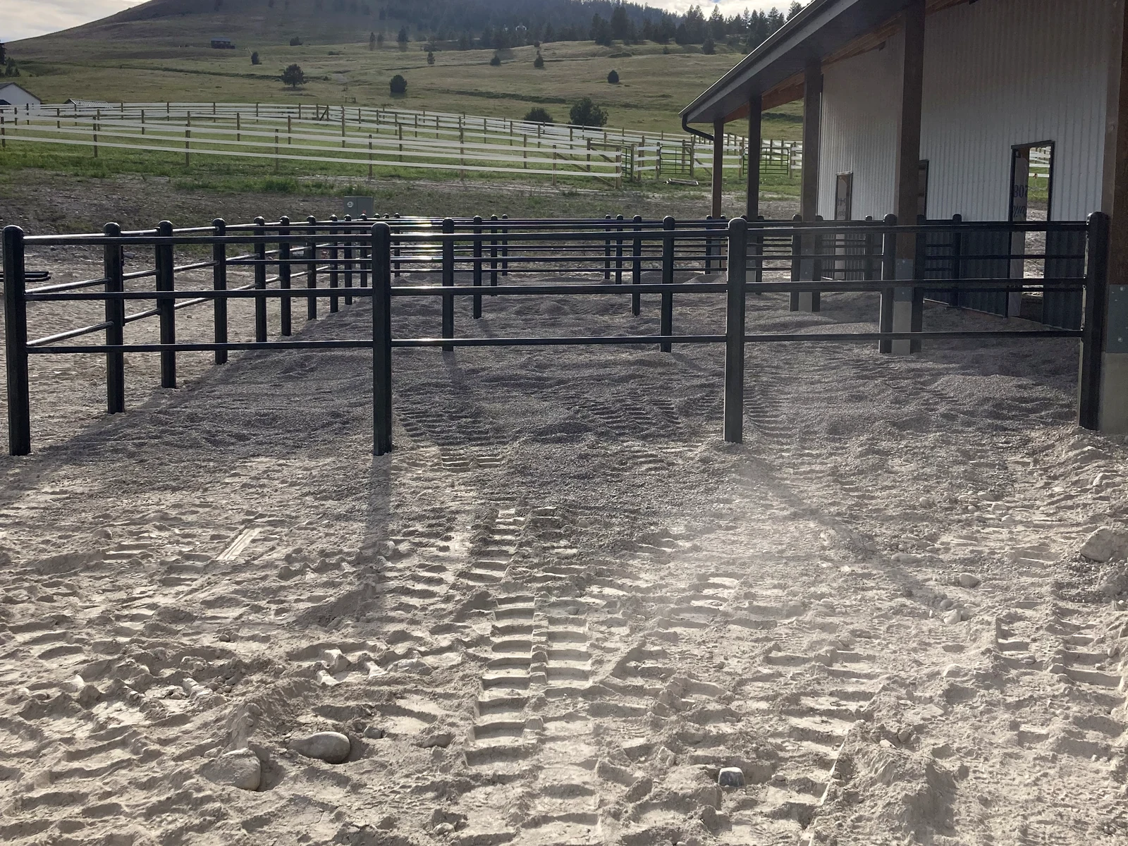 Overview of the black Priefert Estate Fence paddock yard in Big Arm, Montana