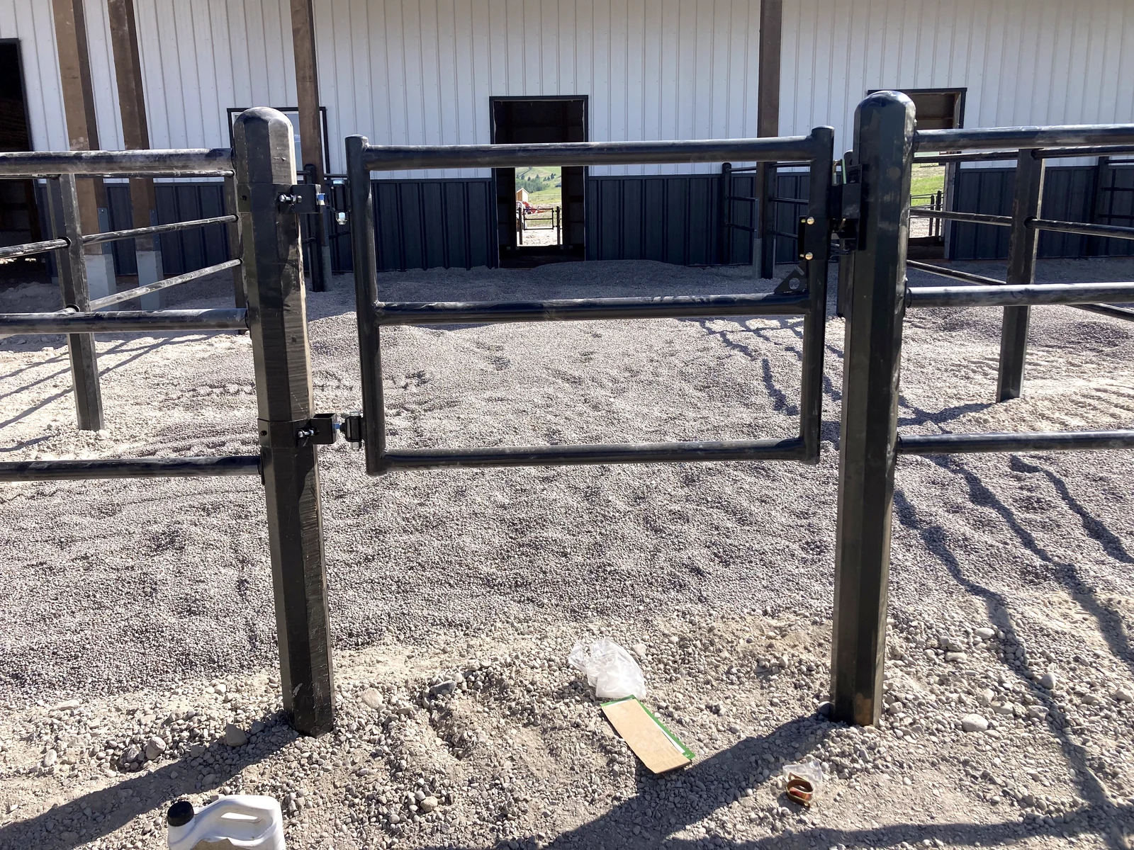 Perspective through a black Priefert Estate Fence gate at the Montana barn paddocks