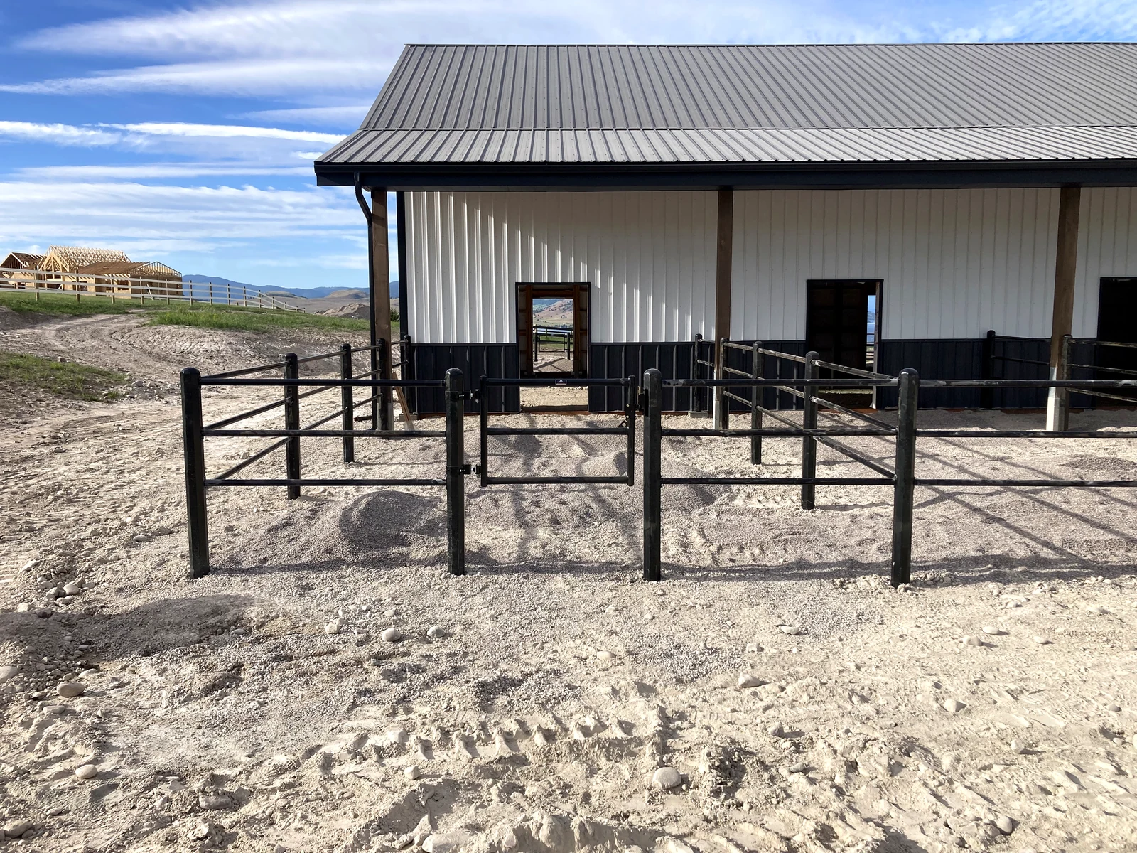 Front view of a black Priefert Estate Fence pen at the Montana barn