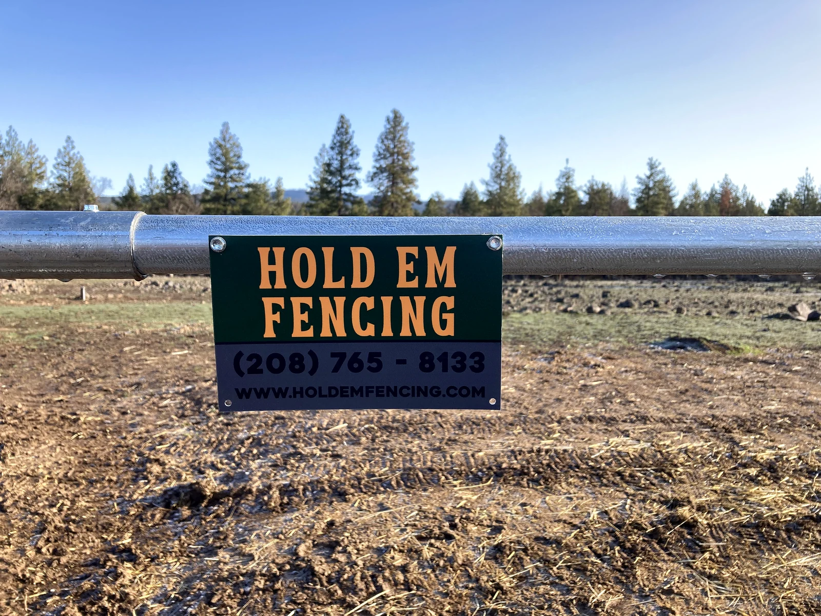 Hold Em Fencing project sign mounted on the Noble Contour fence in Goldendale
