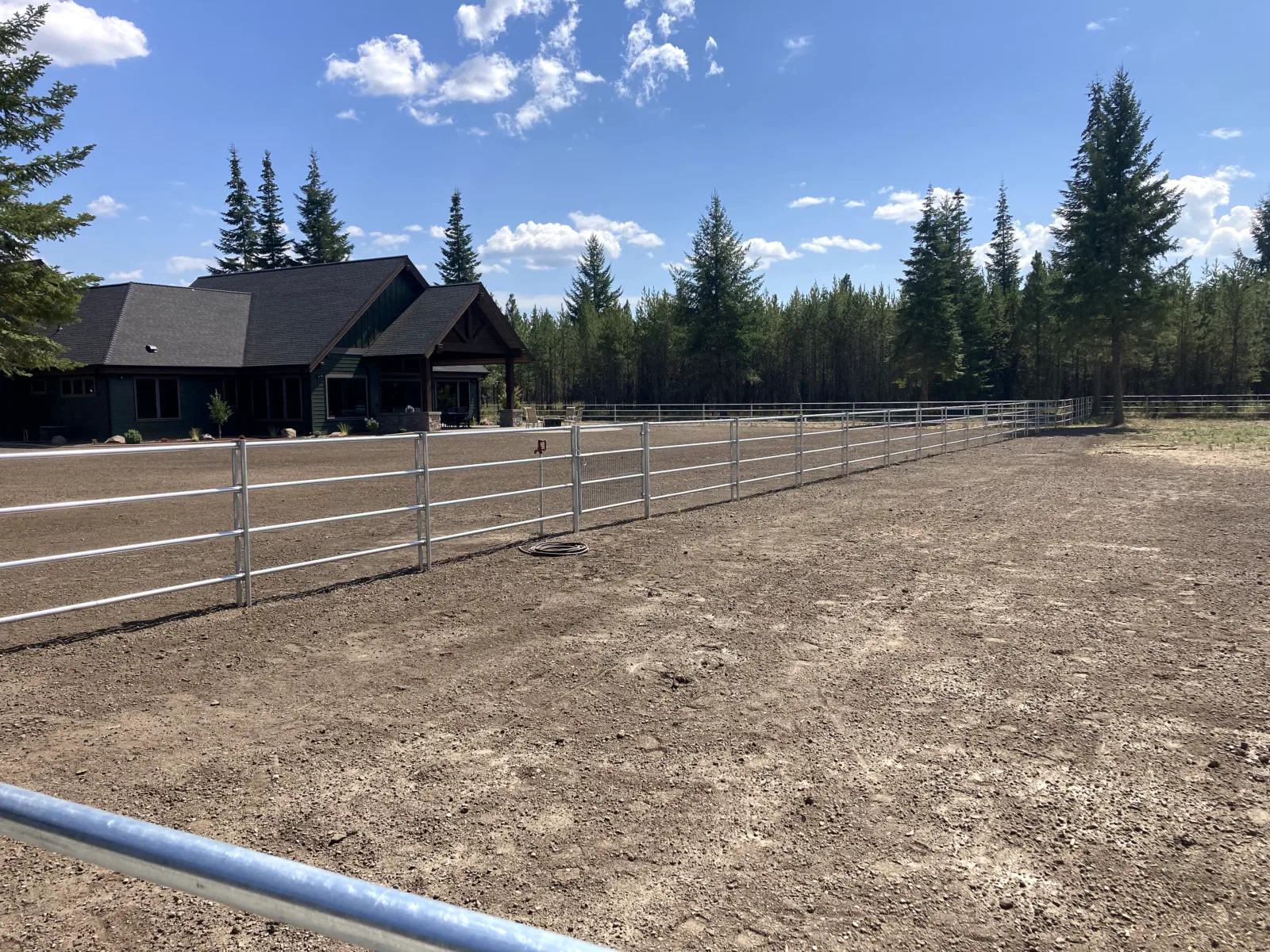 Wide arena and house at the Hayden, Idaho Dream Ranch project