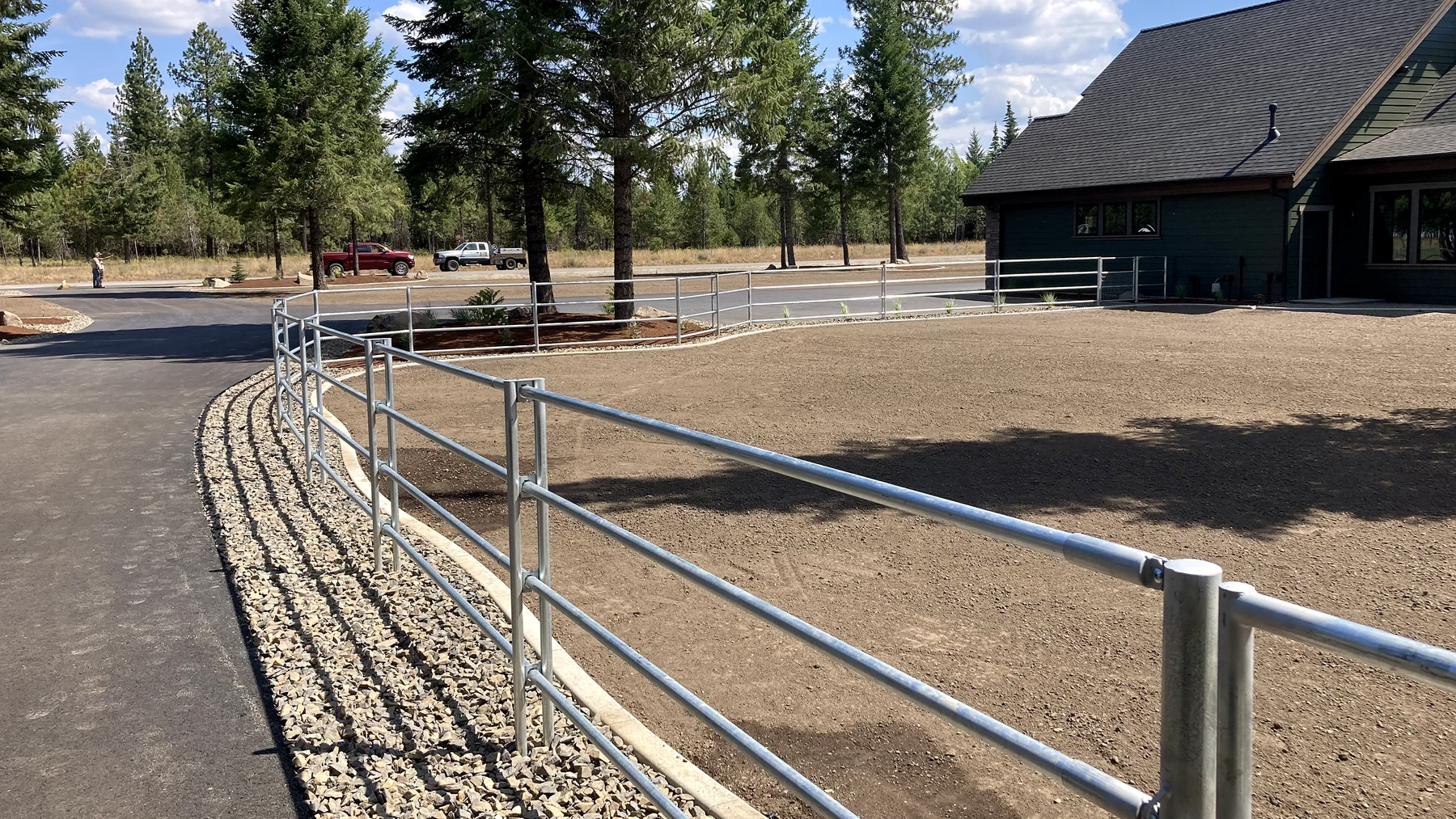 Curved Noble Contour fence tying the yard and house together at the Hayden, Idaho Dream Ranch