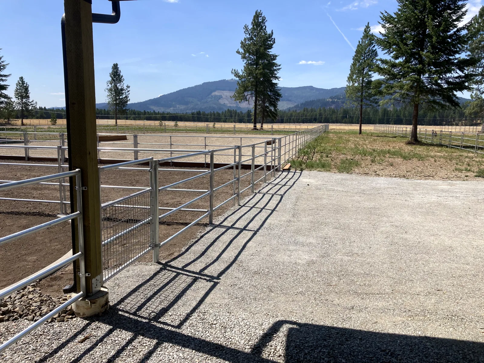 Arena gate and mountain view at the Hayden, Idaho Dream Ranch project