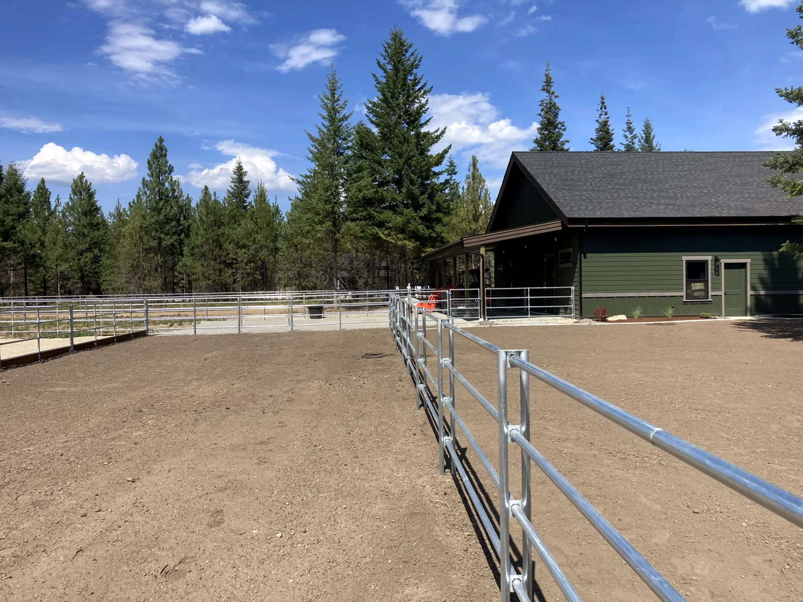 Long arena run toward house at the Hayden, Idaho Dream Ranch project