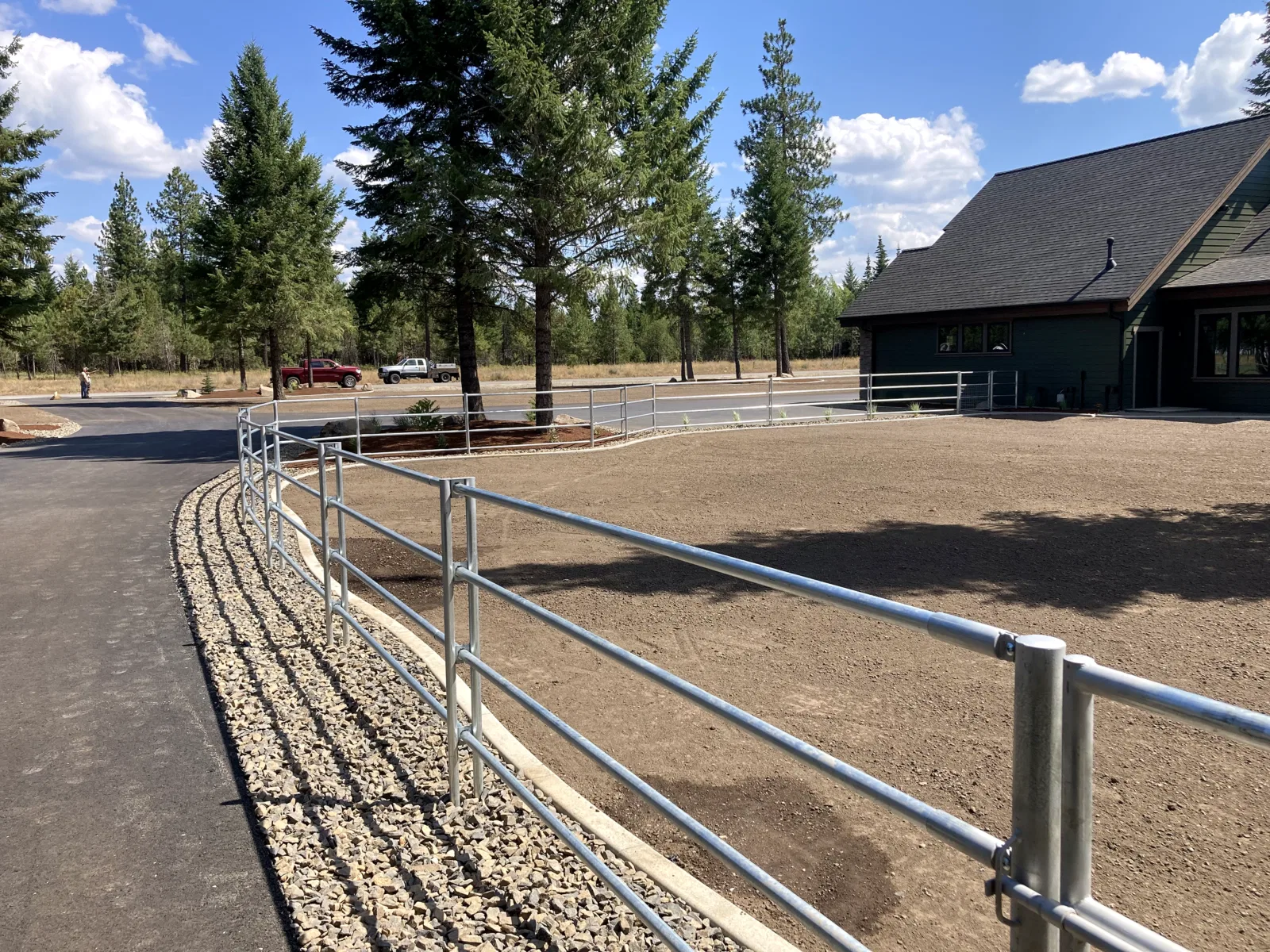 Hero/gallery lead; curved fence at house at the Hayden, Idaho Dream Ranch project