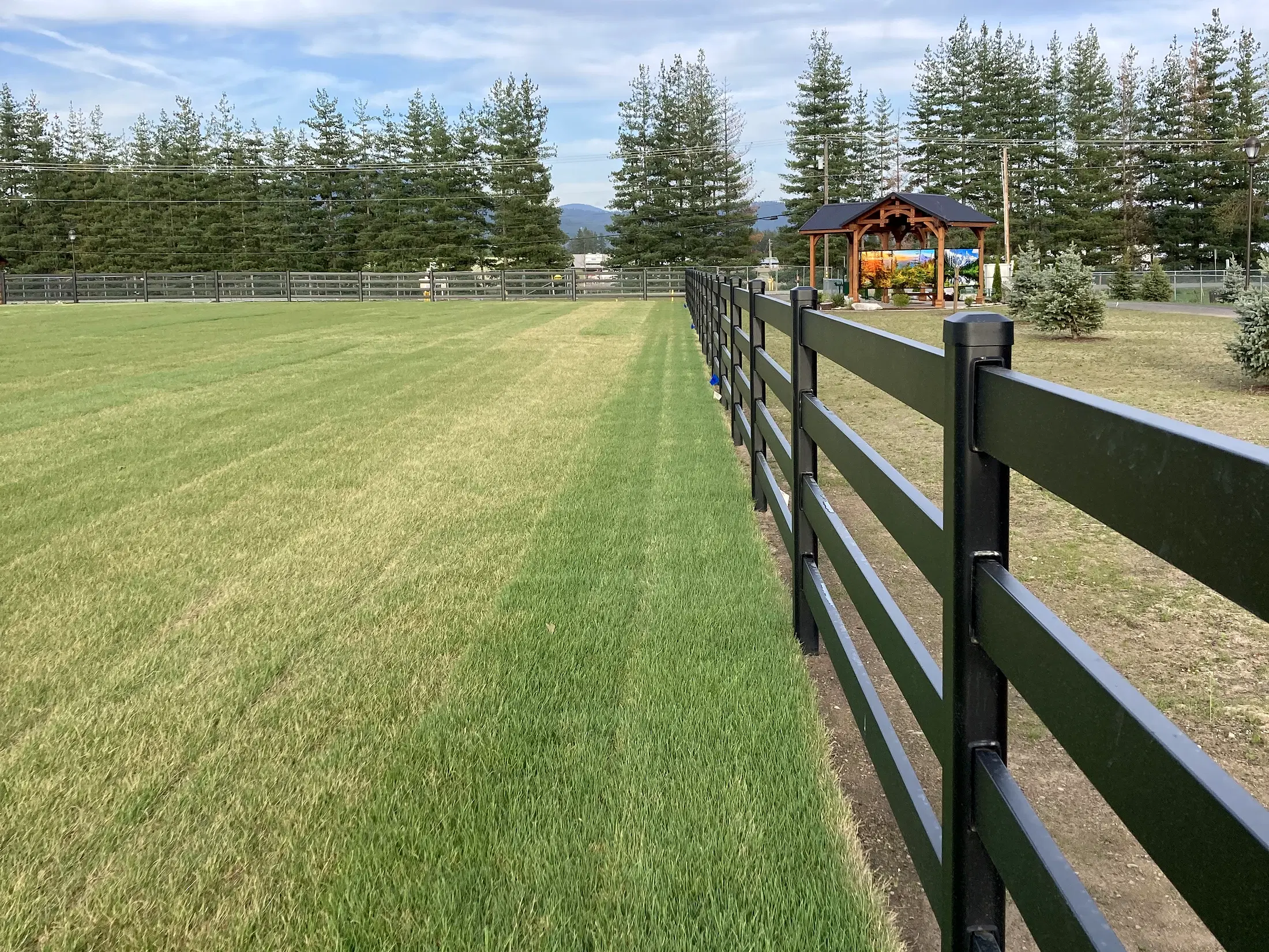 Fence line across field at Faith Walk Community Fitness Park in Coeur d'Alene, Idaho