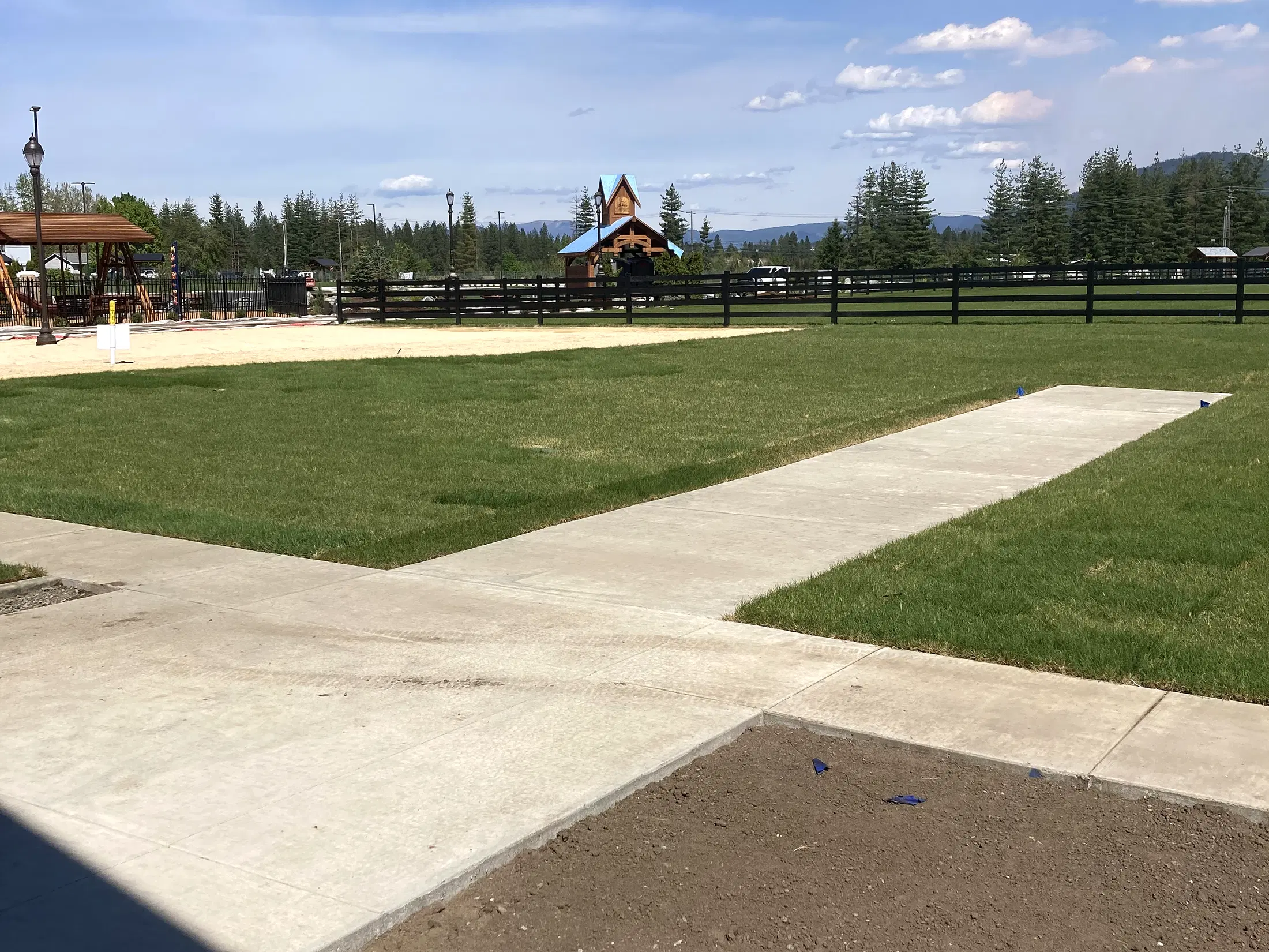 Walkway and field overview at Faith Walk Community Fitness Park in Coeur d'Alene, Idaho