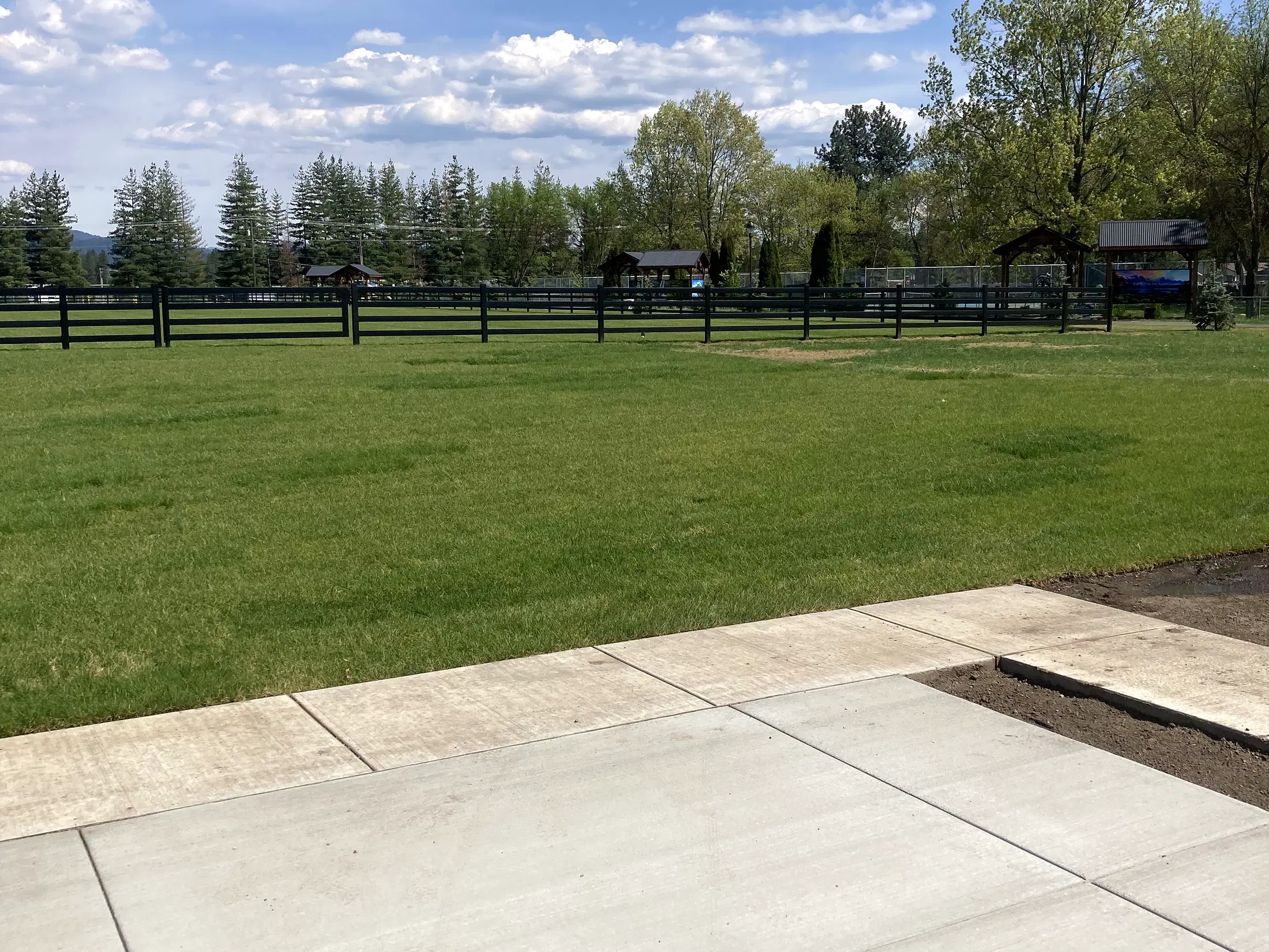 Walkway corner and field at Faith Walk Community Fitness Park in Coeur d'Alene, Idaho