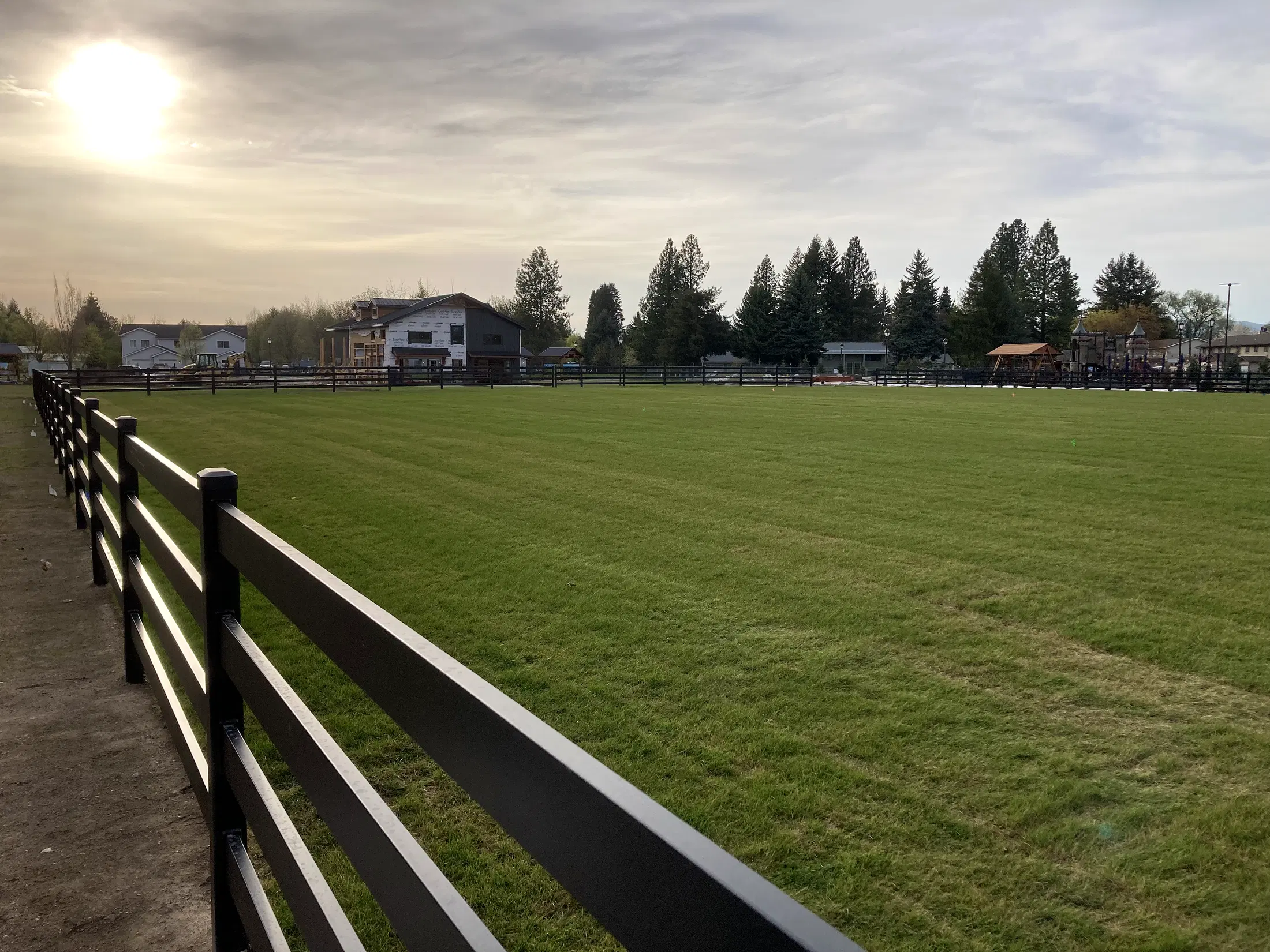Field overview with fence at Faith Walk Community Fitness Park in Coeur d'Alene, Idaho