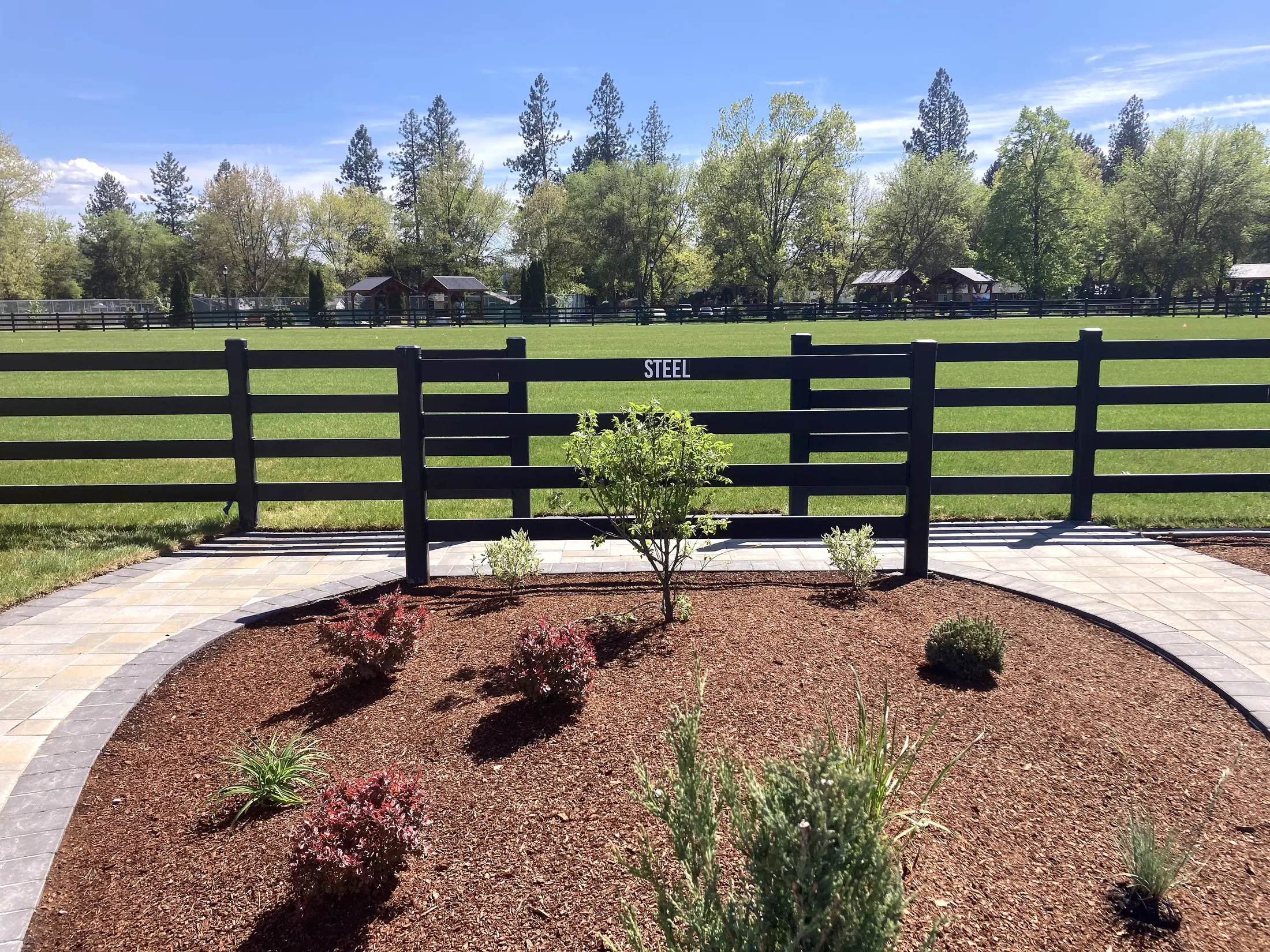Landscaped fence curve at Faith Walk Community Fitness Park in Coeur d'Alene, Idaho