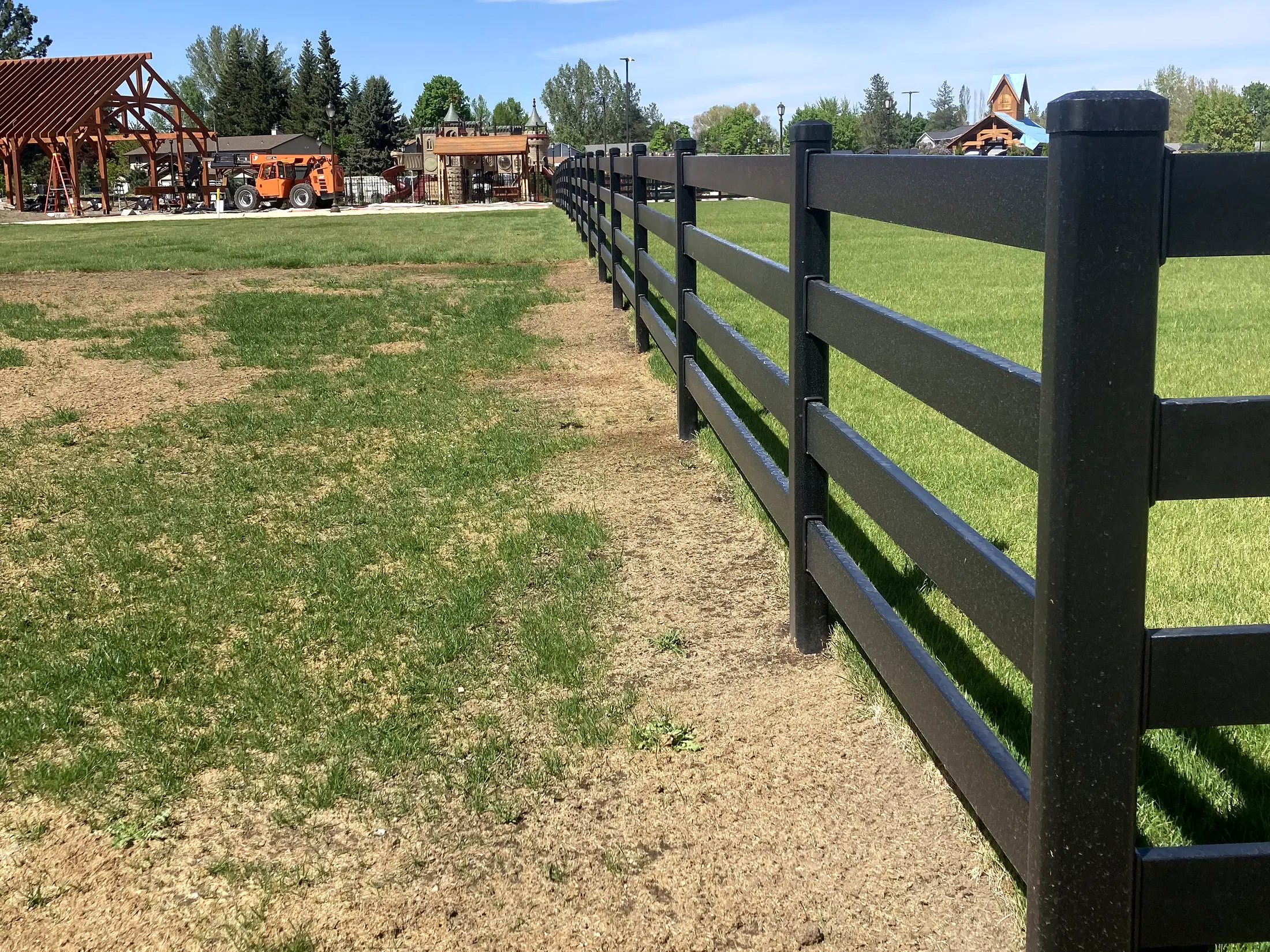 Fence run along field edge at Faith Walk Community Fitness Park in Coeur d'Alene, Idaho