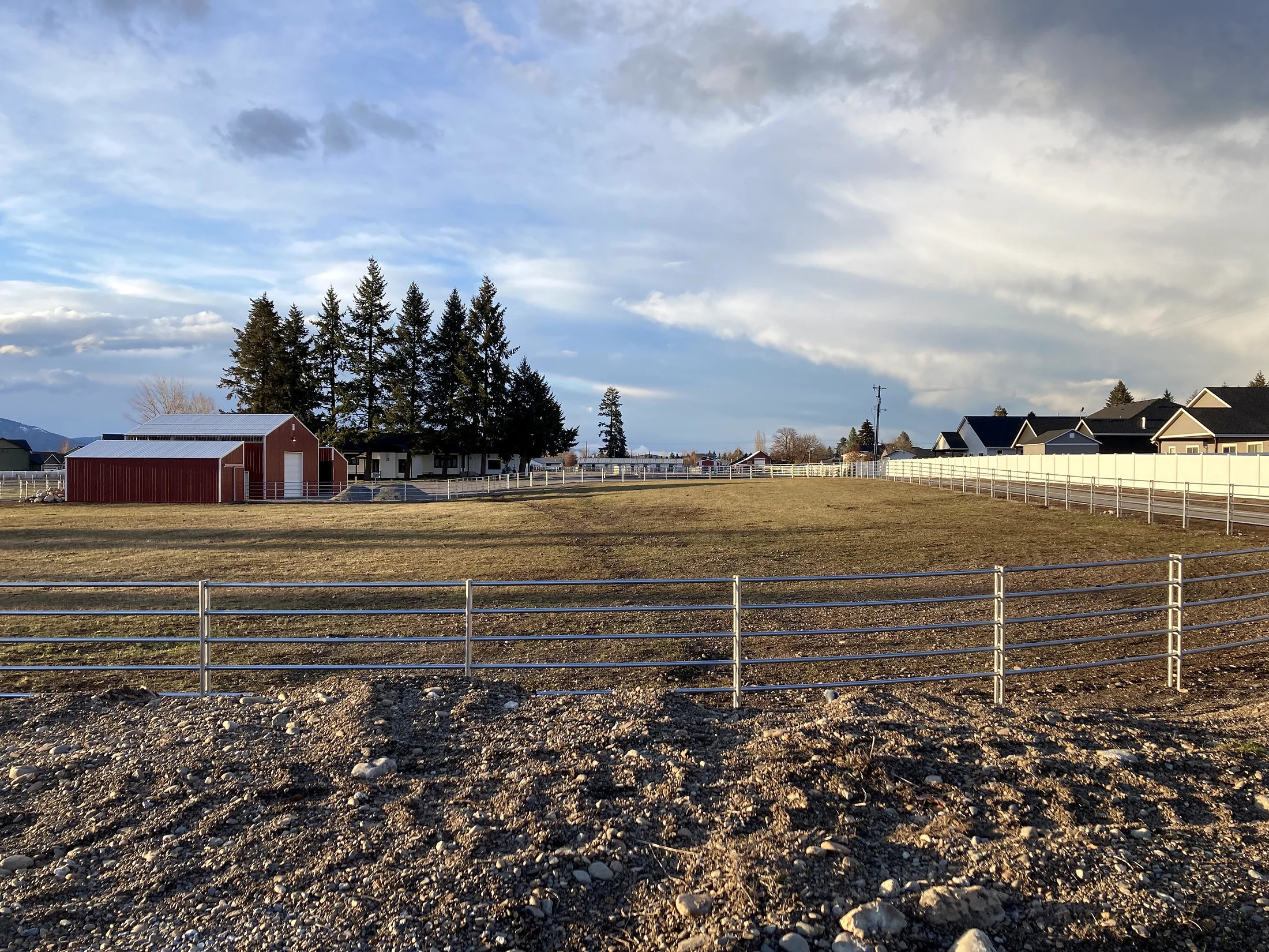 Wide Noble Contour fence view across the field toward the red barn at the Lacey Avenue project