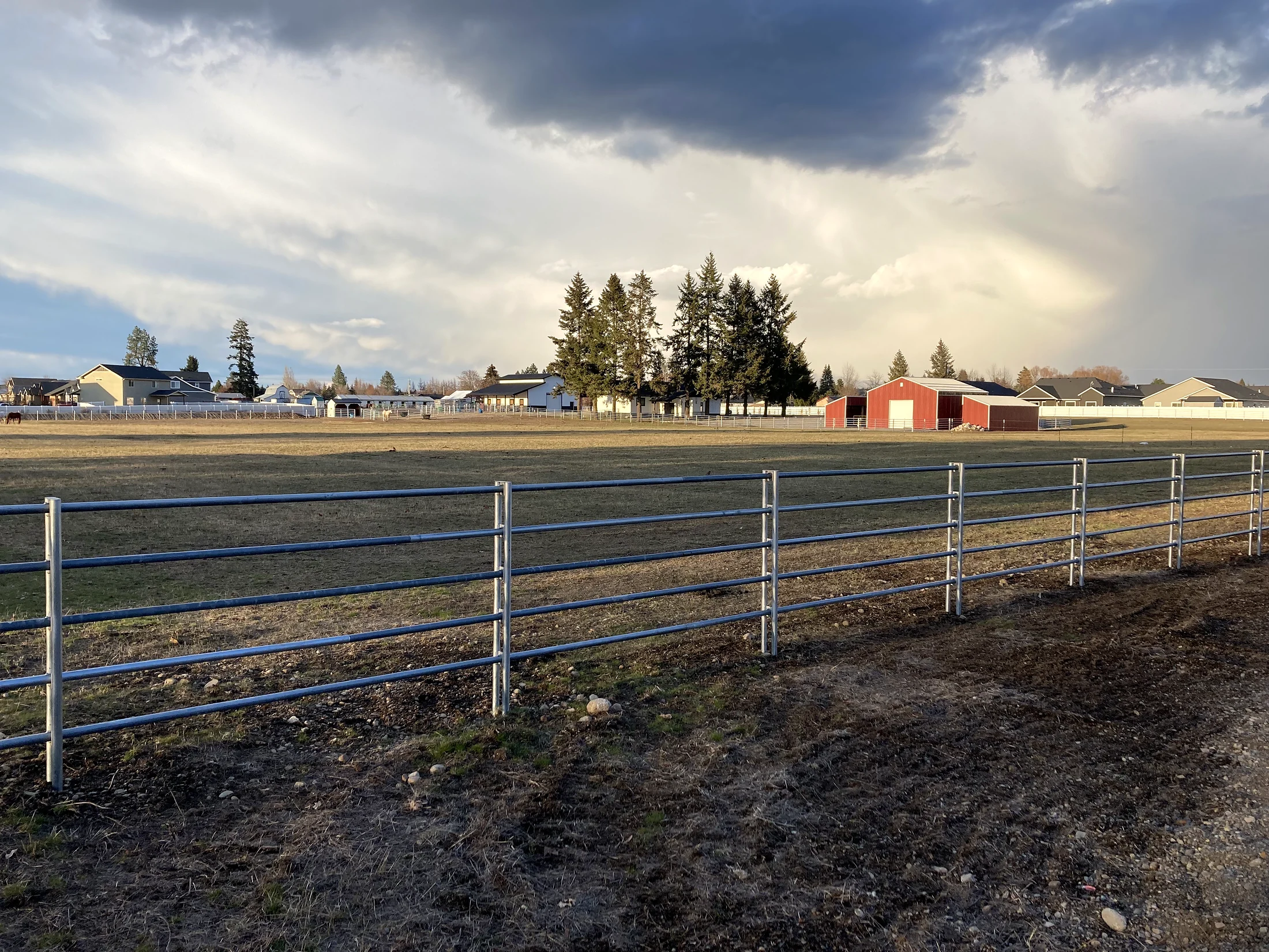 Long Noble Contour fence run beneath dramatic skies at the Lacey Avenue project in Hayden, Idaho