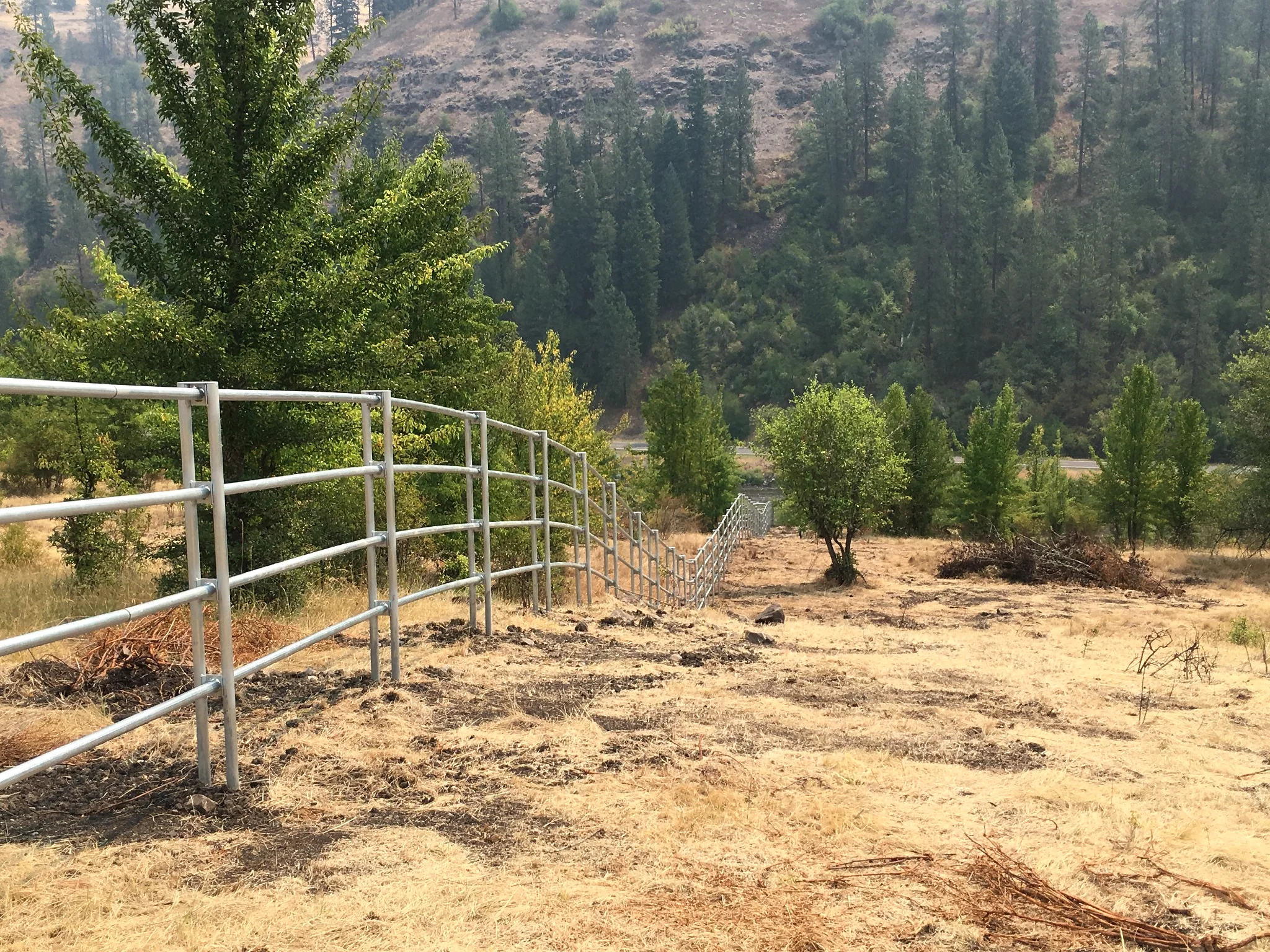 Wide view of Noble Contour fencing across steep ranch ground near Stites, Idaho