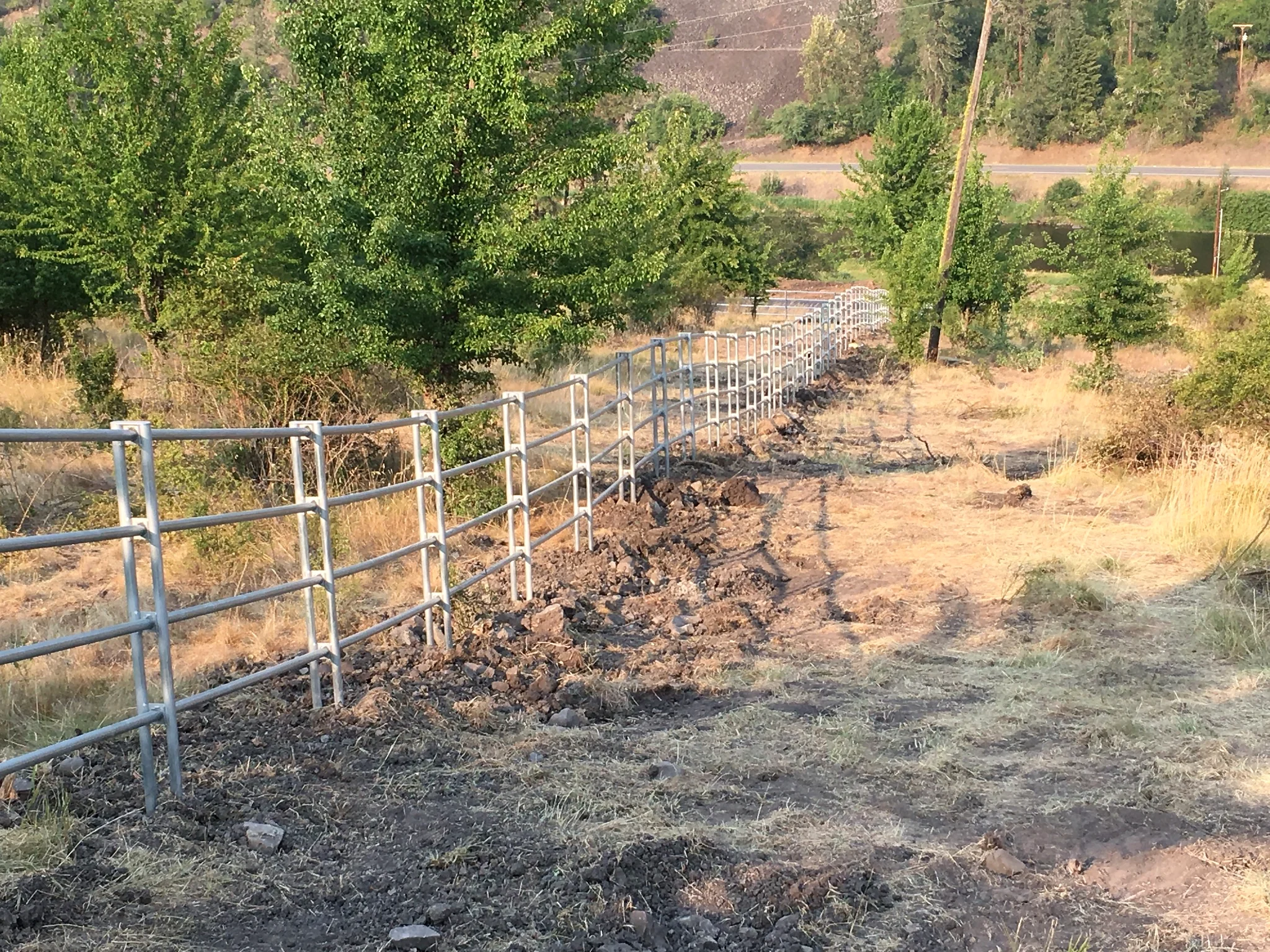 Long downhill run of Noble Contour fence across rugged terrain near Stites, Idaho