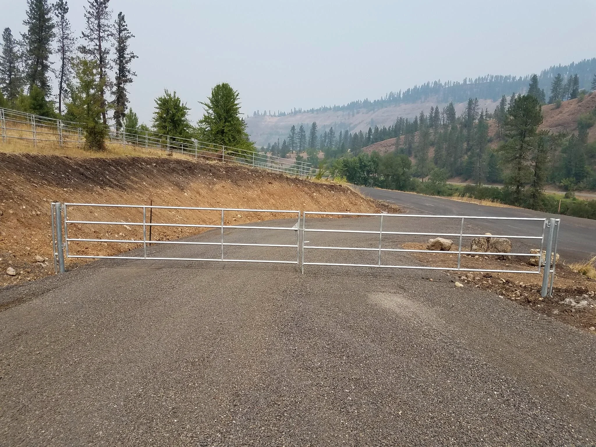 Double driveway gate with Noble Contour fencing and mountain views near Stites, Idaho