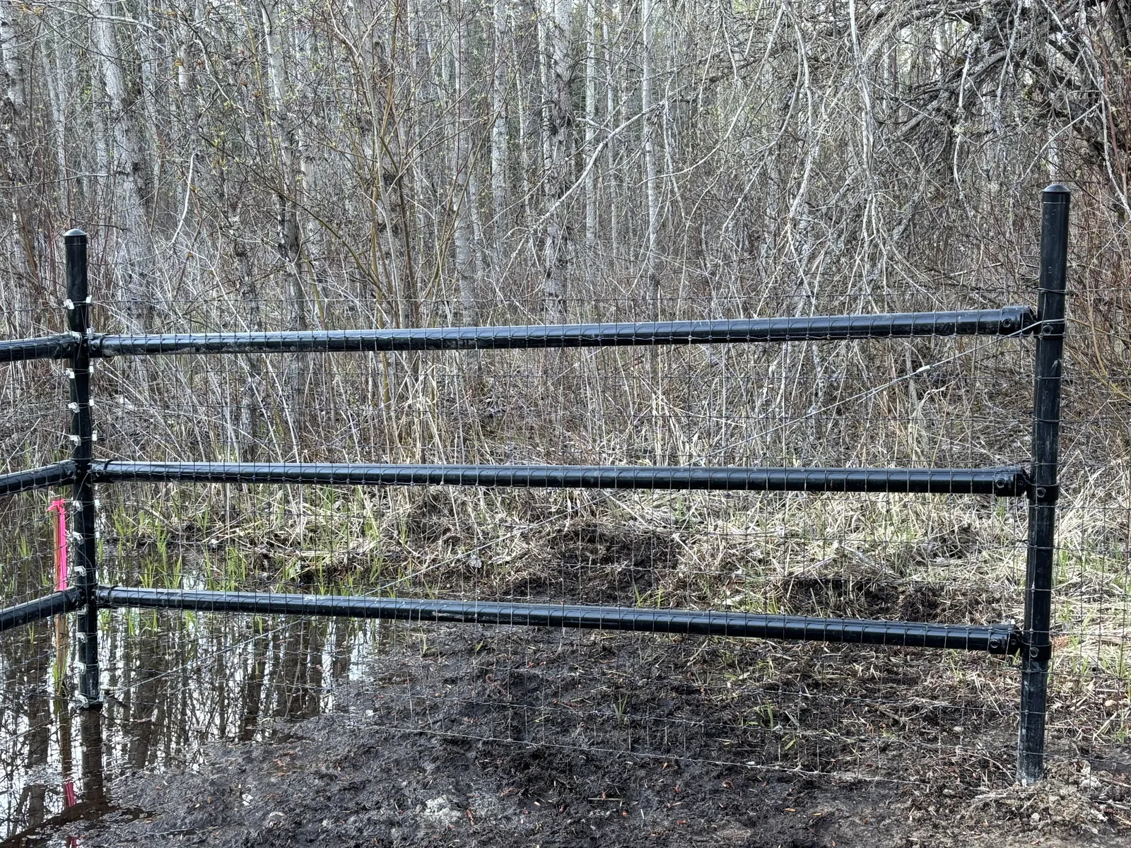Black steel pipe corner and brace assembly for the Frontier mesh fence.