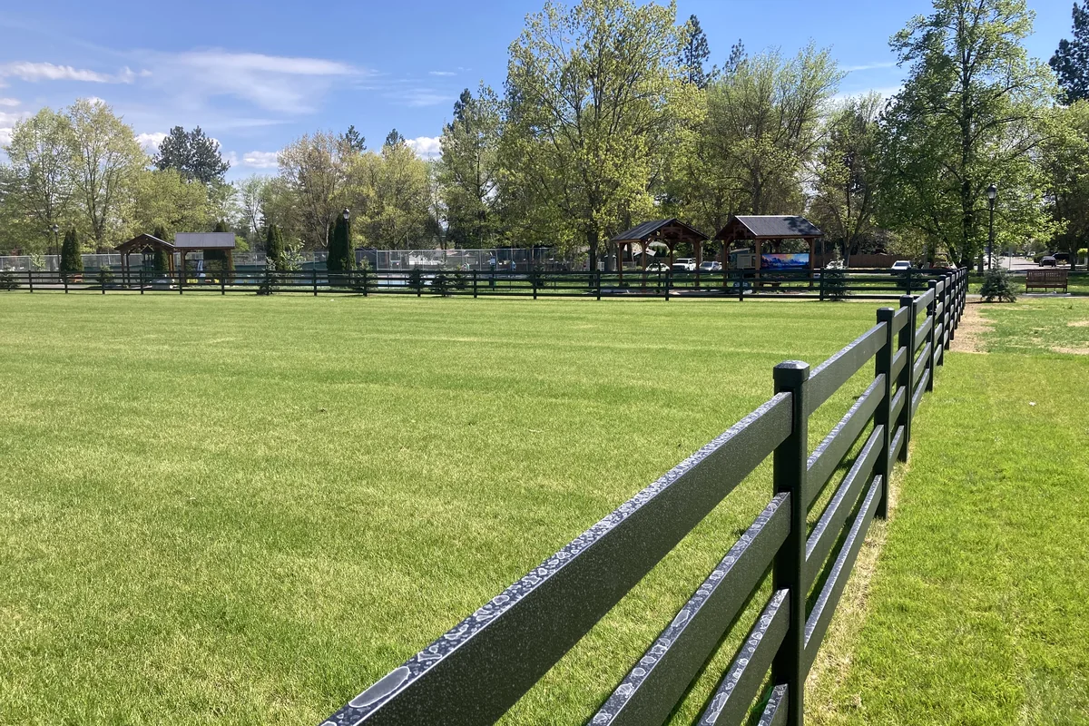 Black three rail Buckley Steel Board fence on a ranch property