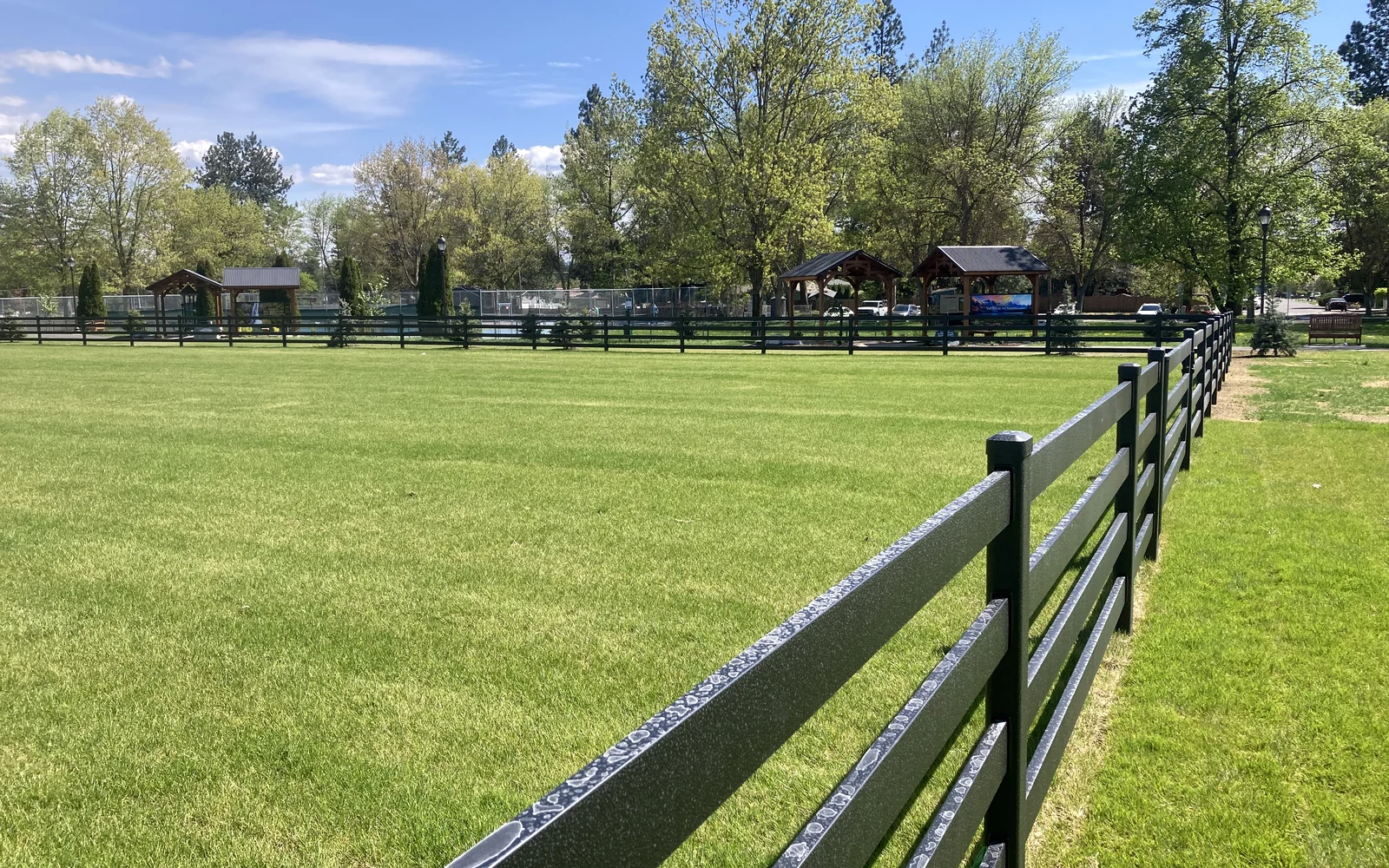 Modern three rail ranch fence on rural acreage
