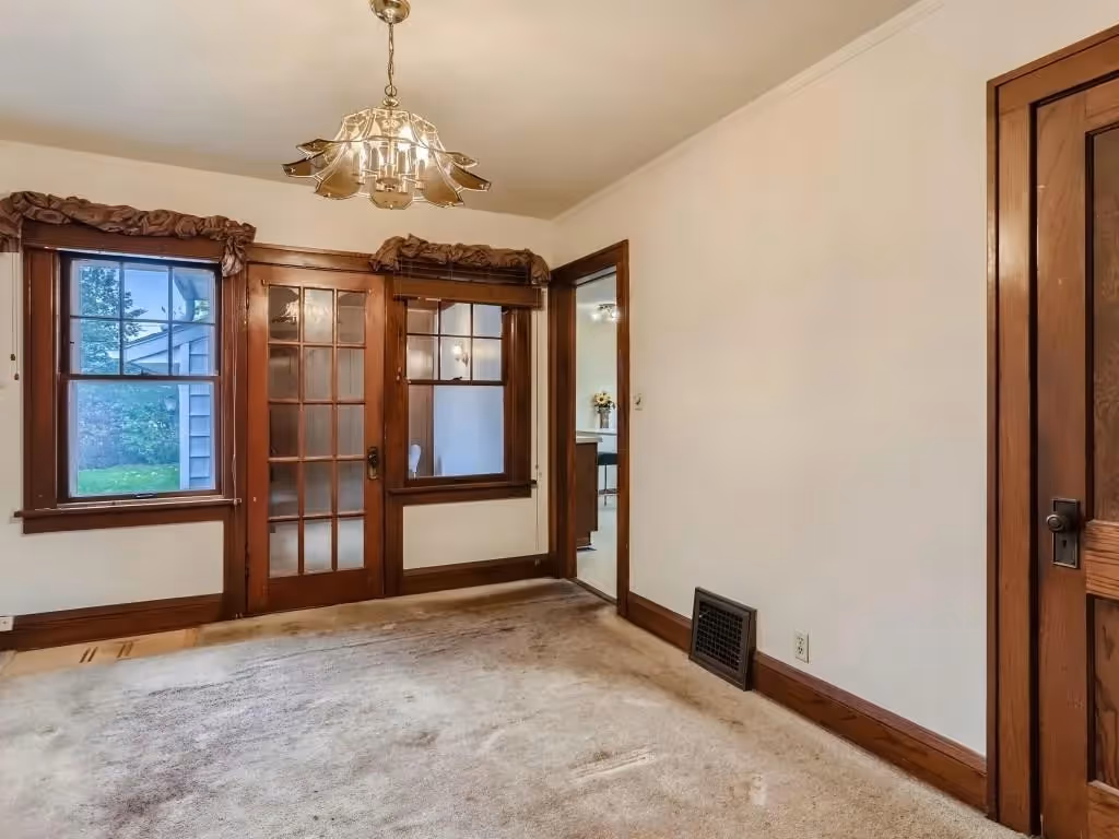 Before view of carpet condition before hardwood was discovered underneath.