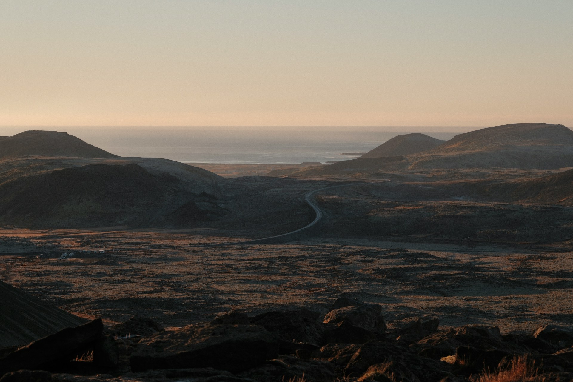 Desert landscape with road leading to the ocean.