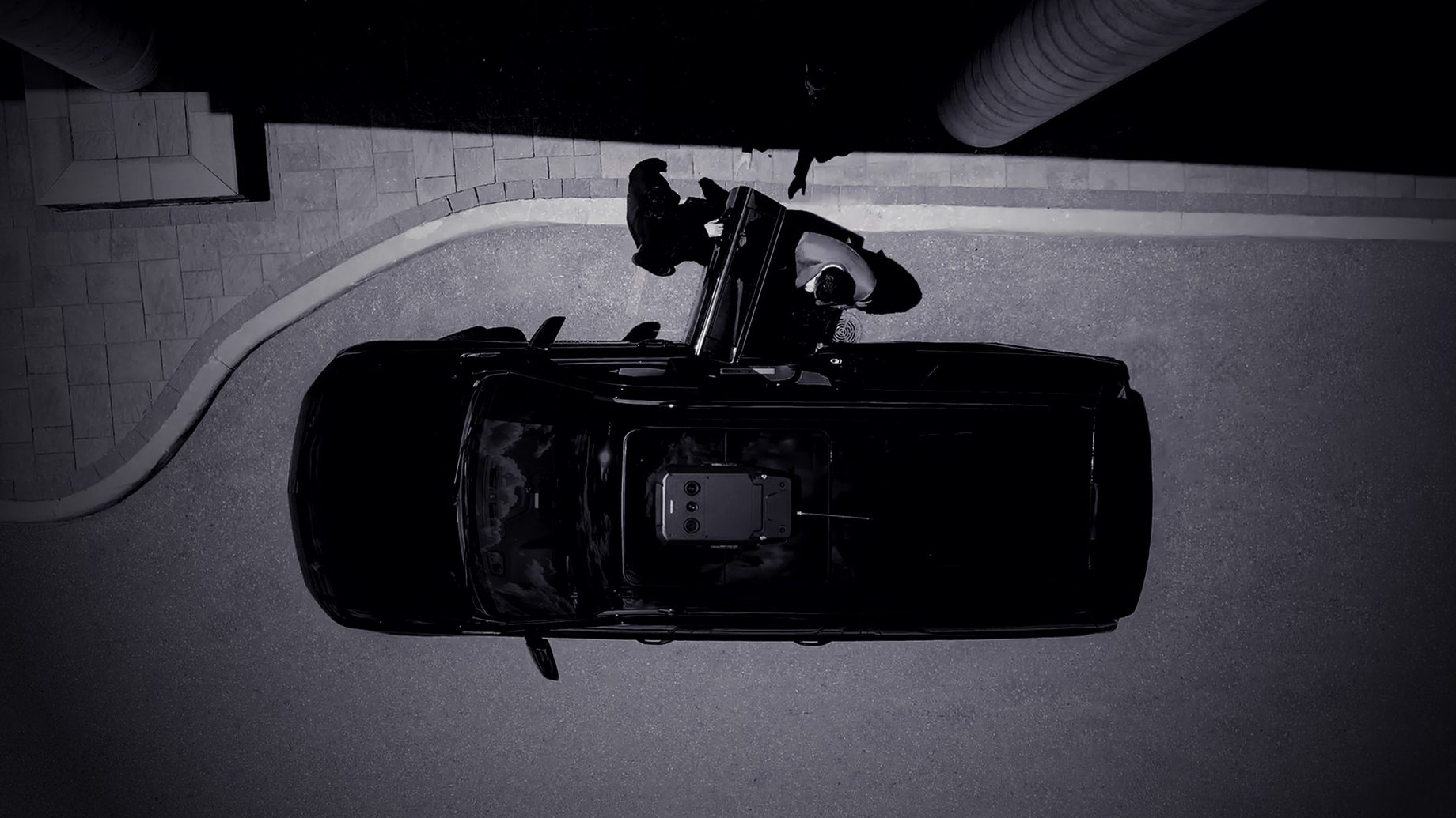 An OZINT protective detail at a client vehicle, seen from above