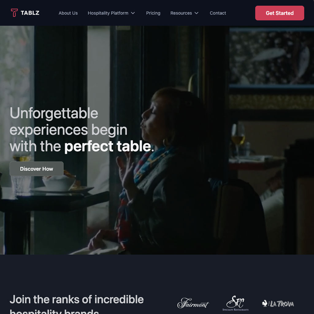 The Tablz.com homepage: dark navigation over a restaurant scene, with the line Unforgettable experiences begin with the perfect table