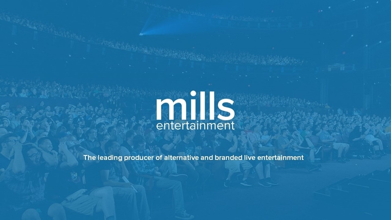 The Mills Entertainment company deck title slide, the logo over a full theatre