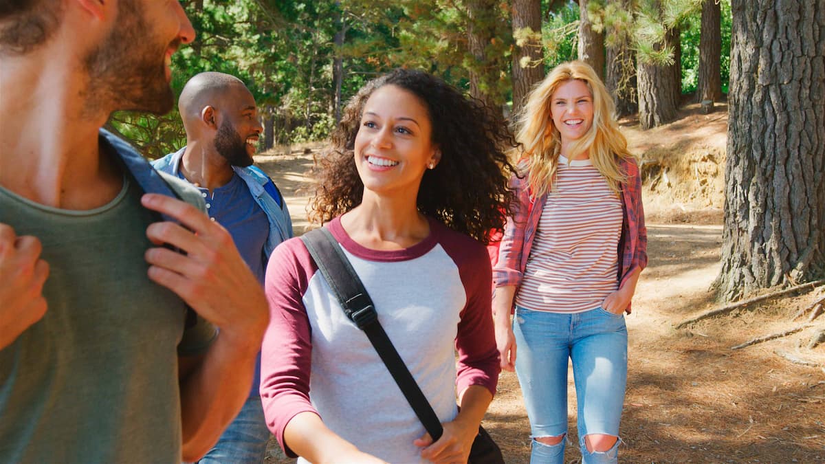 two people walking together outdoors and talking casually