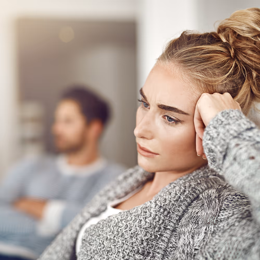 A young woman experiencing relationship anxiety and overthinking, seeking emotional security through attachment therapy at Ray of Hope Counseling in Texas.