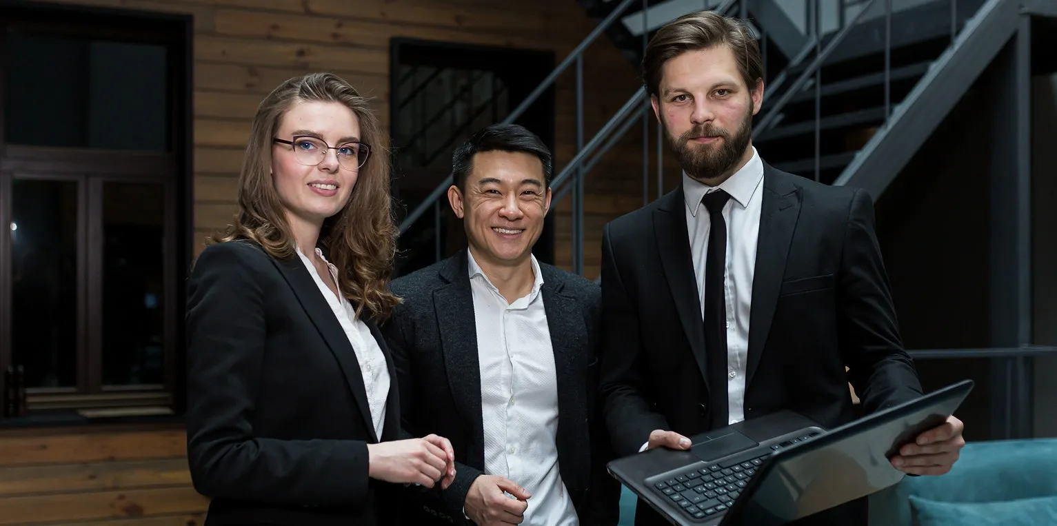 A group of three people standing next to each other.