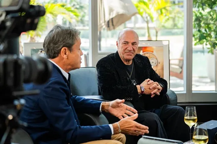 A couple of men sitting next to each other.