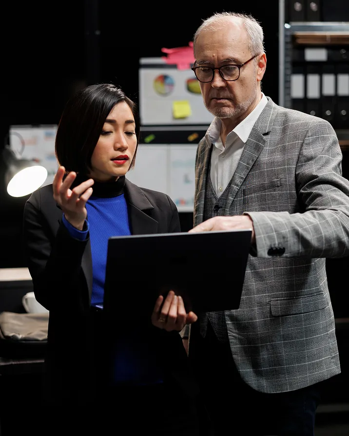 A man standing next to a woman in a suit.