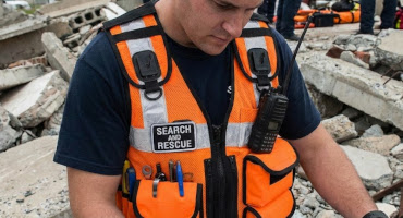 USAR search and rescue team wearing orange protec utility vest