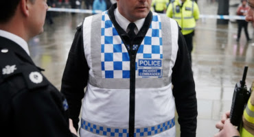 police officer on scene wearing protec police incident commander tabard.