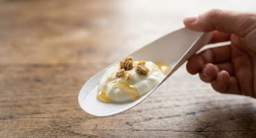 ecotensil cardboard spoon with food on it.
