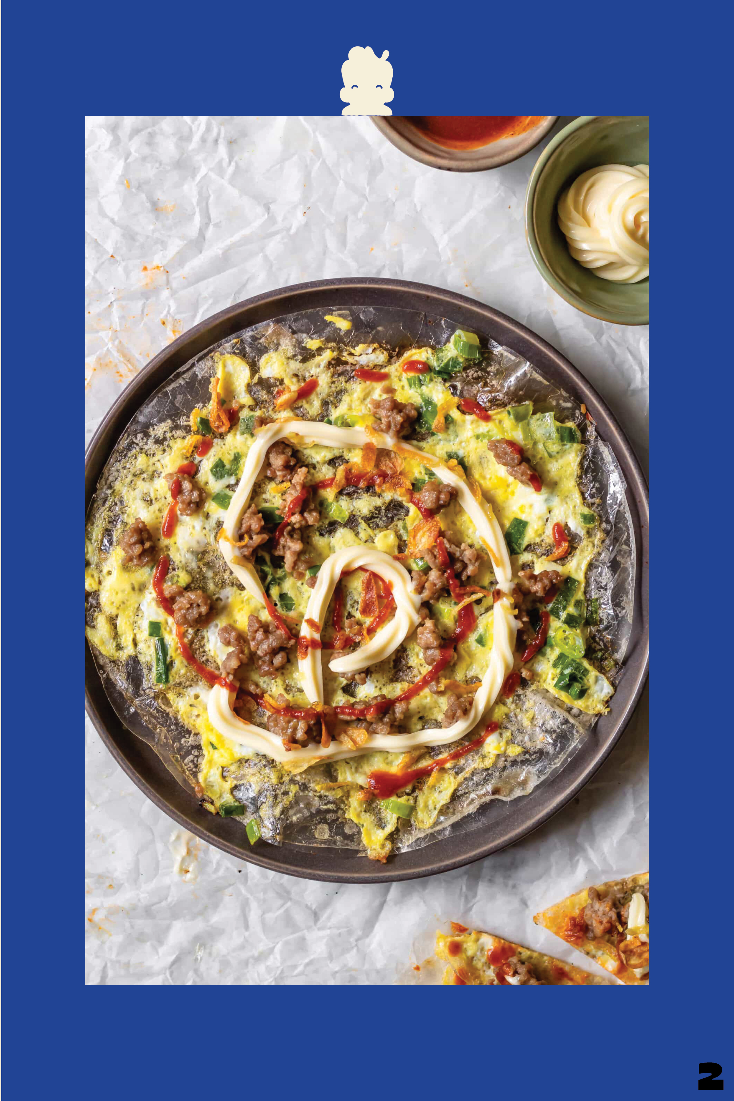 Plate of crispy egg dish topped with cooked ground meat, chopped green onions, mayonnaise, and Sriracha sauce, served with dipping sauces.