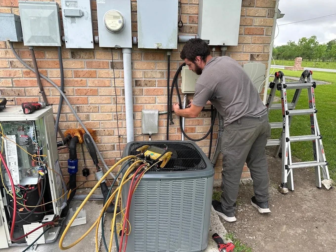 Technician performing HVAC maintenance on an air conditioning unit in spring