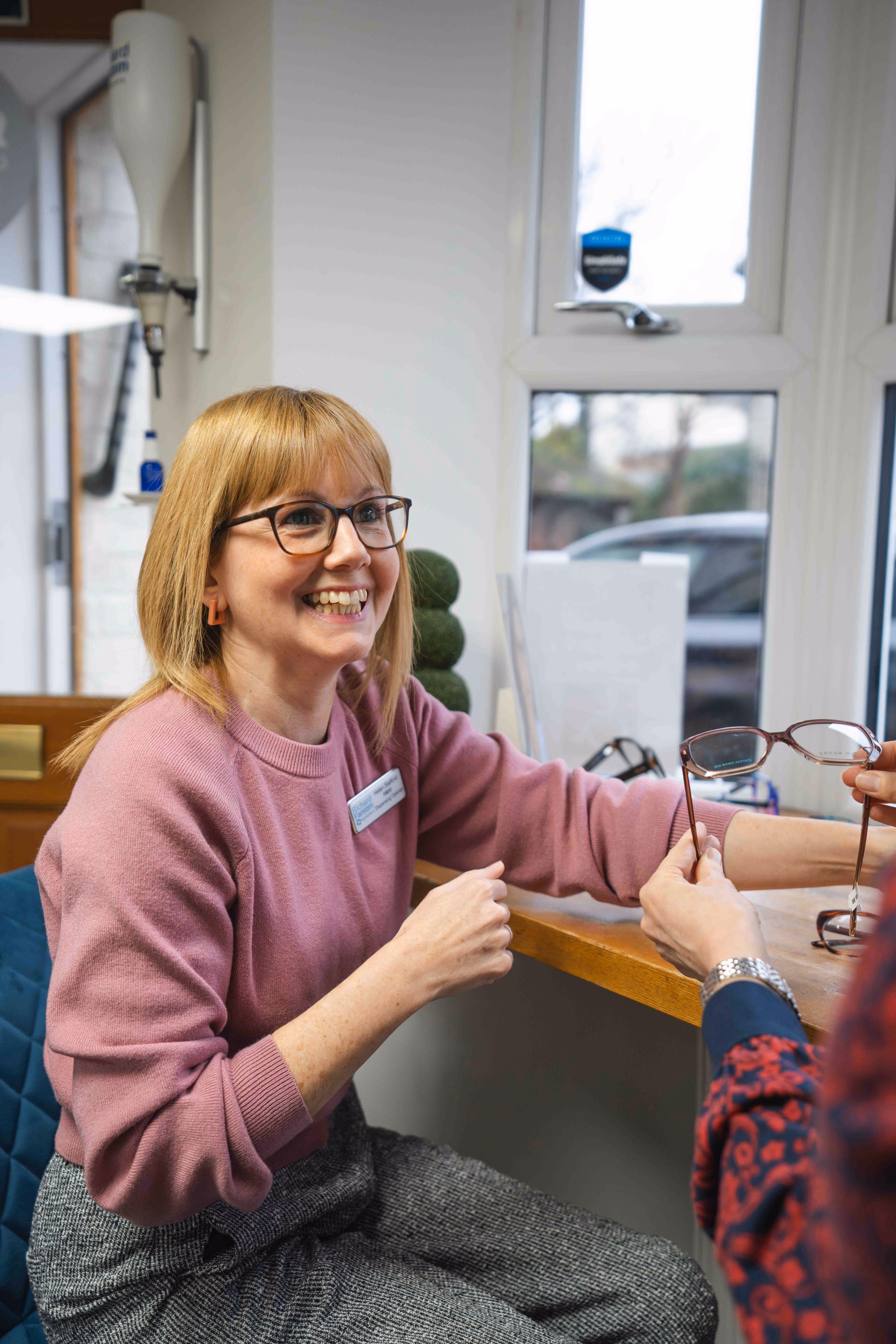 a lady receiving designer womens glasses frames​