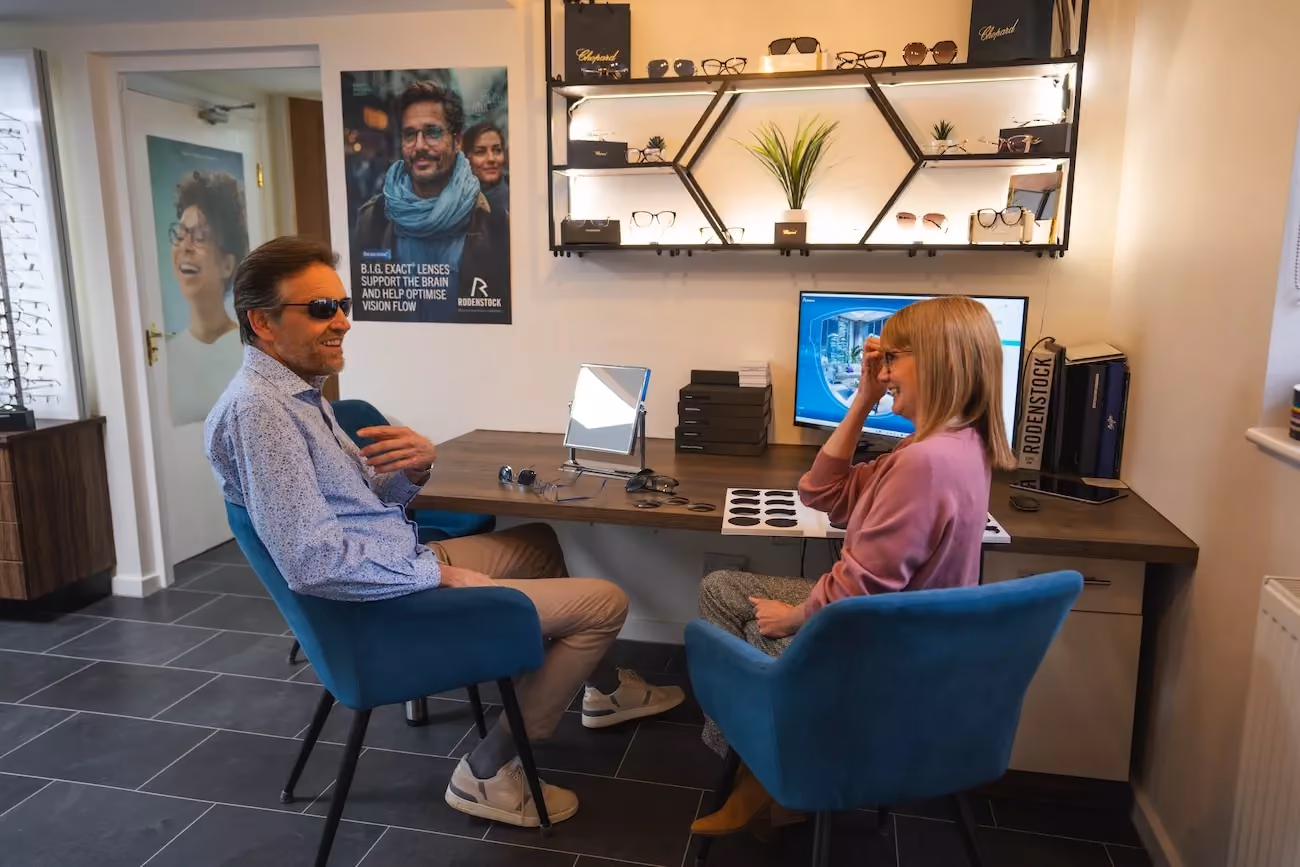 A customer trying on sunglasses with a dispenser at Richard Fantom Eyecare.