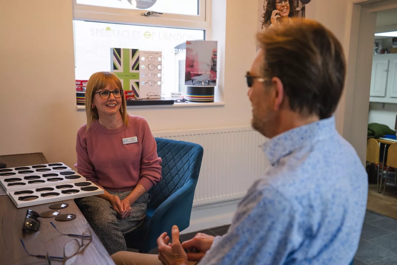 Optical assistant discussing designer frame options with a patient at Richard Fantom Eyecare.