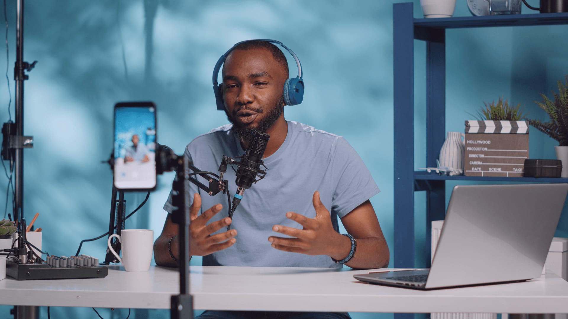 Mann sitzt vor Mikrofon und spricht