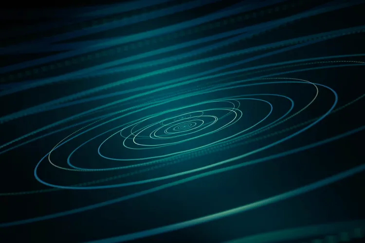 Spiraling blue-green concentric circles on dark abstract background.
