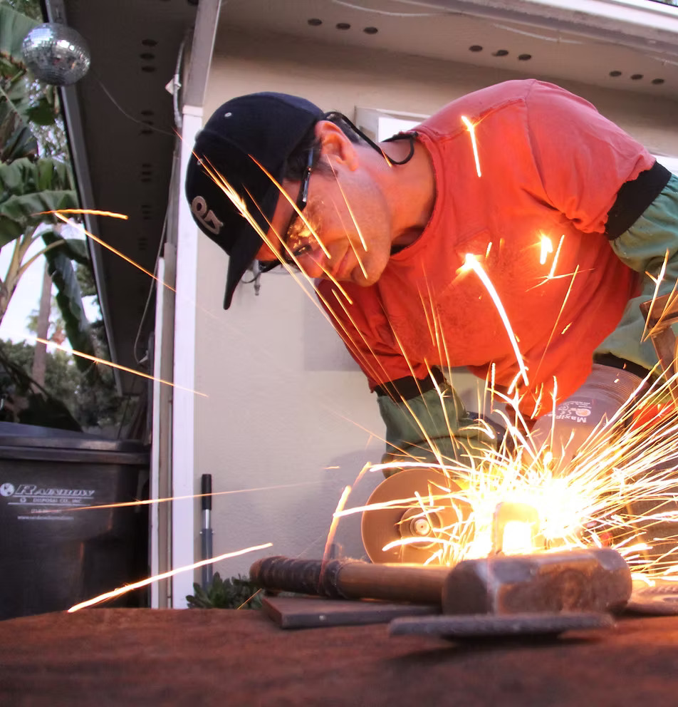 AWS certified professional welder working on custom metal fabrication with precision welding equipment